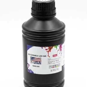 May include: A black plastic bottle containing 500ml of UV curable LED hard ink. The label features a USA flag graphic, the text UV CURABLE LED INK, and a white cap with the letters WH printed on top. The bottle has a ribbed neck and cylindrical body.