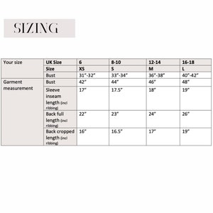 May include: Sizing chart for clothing with measurements in inches for bust, sleeve inseam length, back full length, and back cropped length. The chart includes sizes XS, S, M, and L.