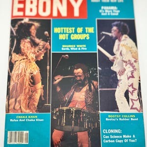 May include: A vintage issue of Ebony magazine featuring a cover with the headline "Hottest of the Hot Groups." The cover includes images of Chaka Khan, Maurice White, and Bootsy Collins. The magazine has a blue and red color scheme.