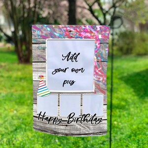 May include: A colourful birthday garden sign with a wooden background and a white frame that says "Add your own pics". There are three empty photo frames below the text and the words "Happy Birthday" at the bottom.