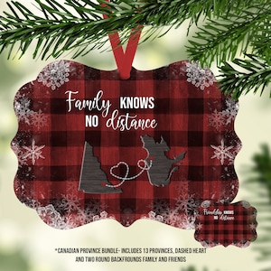 May include: Red and black plaid Christmas ornament with a white snowflake pattern. The ornament features a black silhouette of Canada with a dashed heart connecting British Columbia and Nova Scotia. The text "Family KNOWS NO distance" is printed on the ornament.