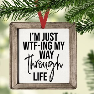 May include: A wooden framed Christmas ornament with the text "I'm just WTF-ing my way through life" on a white background.