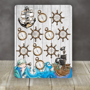 May include: A nautical themed potty training chart with a wooden background. The chart features a large anchor, a pirate ship, and 12 compass and ship wheel stickers. The chart is titled "Cooper's Potty Chart".