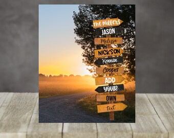 May include: A wooden signpost with multiple directional signs, each bearing a name or text. The signs are in various colors, including brown, black, and yellow. The background features a scenic view of a road at sunset.