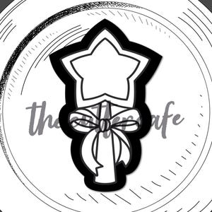 May include: Black and white line art illustration of a princess wand with a star on top and a bow in the middle. The text "princess wand" is below the image.