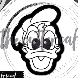 May include: Black and white cartoon image of a duck's face, with a large open beak and a chef's hat. The text "duck friend" is below the image. The image is on a white plate with the text "the cutter cafe" at the top.