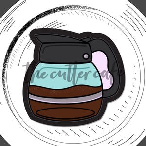 May include: A coffee pot cookie cutter with a black handle and lid, filled with brown coffee. The cutter is on a white plate with a black outline. The text "coffee pot" is below the cutter.