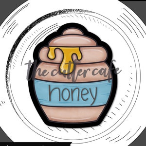 May include: A brown honey pot with a blue label that says "honey". There is a yellow drip of honey coming out of the pot.