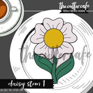 May include: A white daisy with a yellow center and green leaves on a white plate. The text "daisy stem 1" is below the plate.