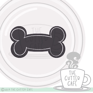 May include: Black and white illustration of a bone shape with the text "The Cutter Cafe" inside. A stylized mug with steam coming from it says "The Cutter Cafe" in black text.