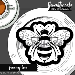 May include: Black and white illustration of a honey bee on a white plate. The bee has a black and white striped abdomen and wings. The text "honey bee" is below the plate.