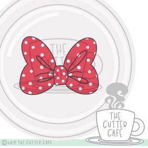 May include: Red and white polka dot bow with a simple outline. The bow is on a white background with a gray circle behind it. The text "THE CUTTER CAFE" is on a gray mug with steam coming from it.