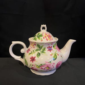 Teapot with Pink and Green Flowers on a White Background