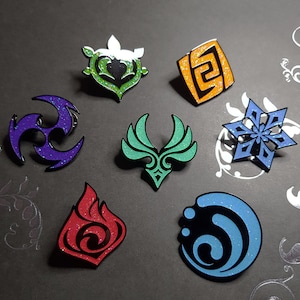 May include: Eight enamel pins with glitter accents depicting different symbols. The symbols include a snowflake, a flame, a swirl, a square with a pattern, a winged creature, a three-pointed star, and a heart-shaped symbol.