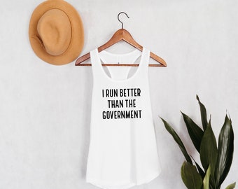 May include: White tank top with the text "I run better than the government" printed on the front.