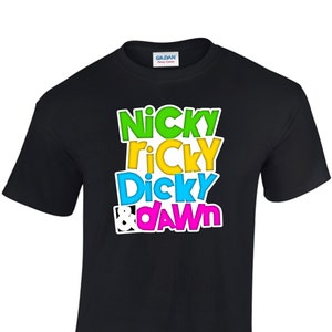 May include: Black t-shirt with a colorful graphic print that reads "Nicky Ricky Dicky & Dawn".