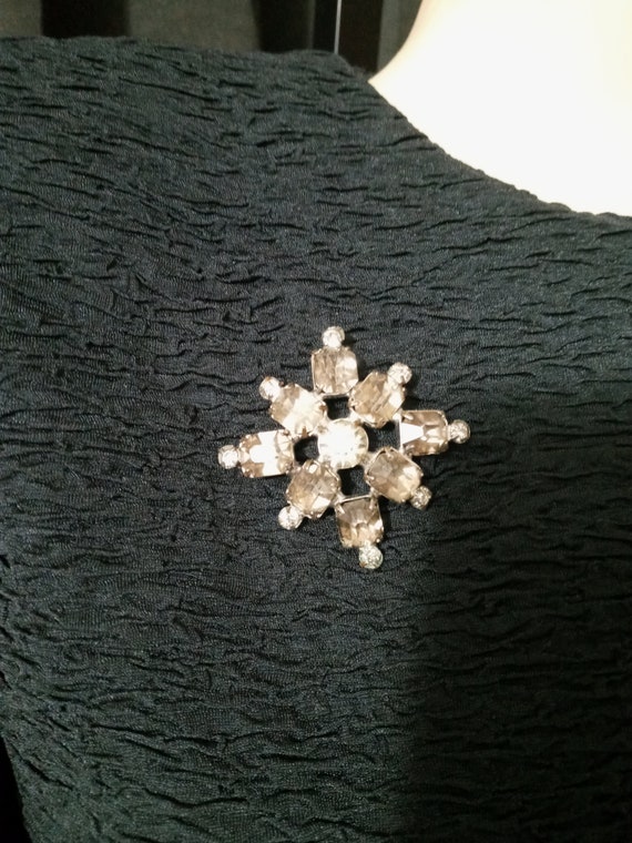 Vintage silver and smoke grey snowflake brooch