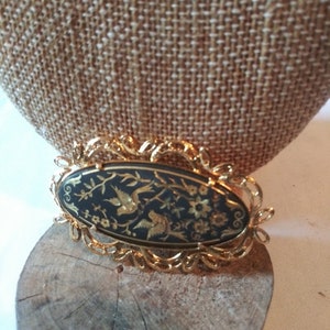 Vintage gold and black oval brooch