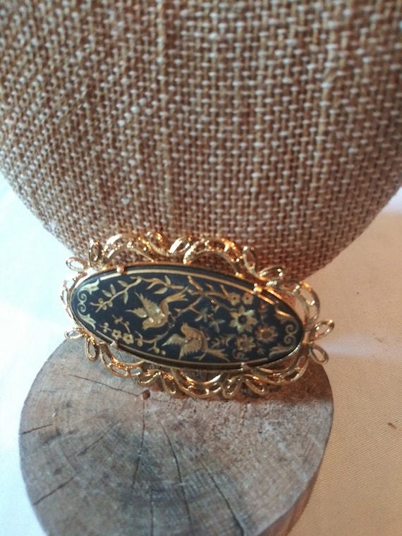 Vintage gold and black oval brooch