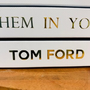 May include: A white box with gold lettering that reads "Them In You" and "TOM FORD".