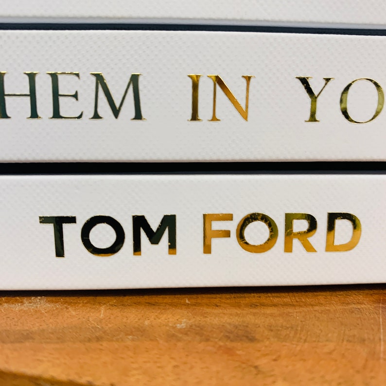 May include: A white box with gold lettering that reads "Them In You" and "TOM FORD".