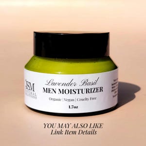 May include: A jar of Lavender Basil Men Moisturizer. The jar has a black lid and a white label with text that reads "Organic | Vegan | Cruelty Free" and "1.7oz". The moisturizer inside is light green.