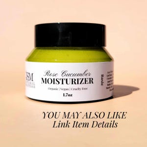 May include: A jar of Rose Cucumber Moisturizer with a black lid. The label reads "Rose Cucumber MOISTURIZER" and "Organic | Vegan | Cruelty Free". The jar contains 1.7 oz of product. The text "YOU MAY ALSO LIKE Link Item Details" is at the bottom.