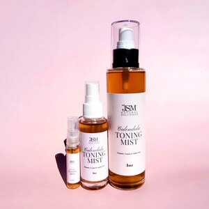 May include: Three bottles of Calendula Toning Mist, with the largest bottle containing 118 ml. The bottles are filled with a golden liquid and have white labels with black text. The bottles are labeled with the brand name "JSM Natural Solutions".