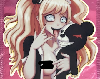 May include: A sticker featuring a blonde anime-style character with blue eyes, a long tongue, and sharp nails, holding a black and white bear. The character is wearing a black and white outfit. The sticker is on a pink background.