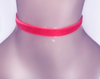 May include: A red velvet choker necklace on a mannequin.