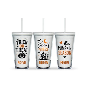 May include: Three clear plastic tumblers with lids and straws, each featuring Halloween-themed graphics in black and orange. The designs include the text Trick or Treat with Noah, Spooky Vibes with Brian, and Pumpkin Season with Mary.