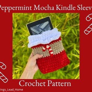 May include: Crochet pattern for a peppermint mocha Kindle sleeve. The sleeve is red, brown, and white with a candy cane design. The sleeve is being held by a hand, and a Kindle is inside the sleeve.