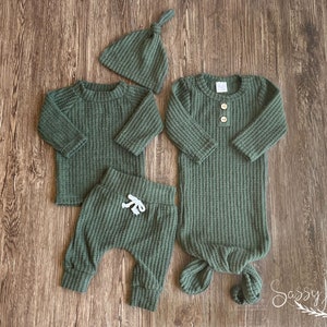 Newborn baby boy dark emerald green waffle knit knotted baby gown and outfit in waffle knit. Dark green long sleeve shirt, pants, tie hat, and knotted baby gown 0-3 months.