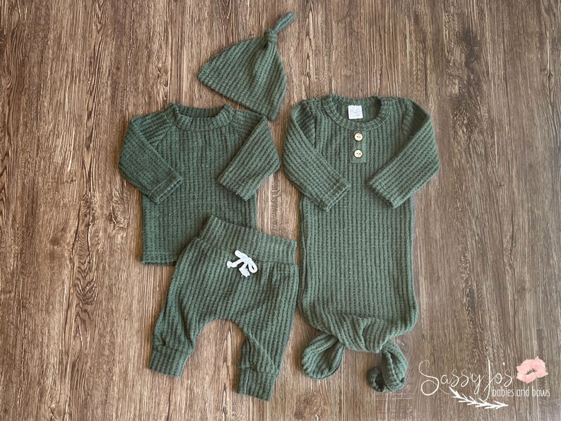Newborn baby boy dark emerald green waffle knit knotted baby gown and outfit in waffle knit. Dark green long sleeve shirt, pants, tie hat, and knotted baby gown 0-3 months.