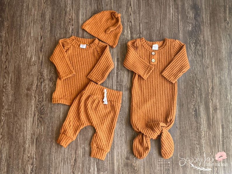 Fall newborn baby coming home outfit. Rust orange (copper) colored waffle knit long sleeve shirt, pants, tie hat and knotted baby gown in 0-3 months.