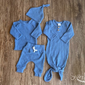 Newborn Baby boy knotted gown and coming home outfit set. Blue waffle knit baby girl outfit with long sleeve shirt, pants, tie hat, and knotted baby gown with two wooden buttons.