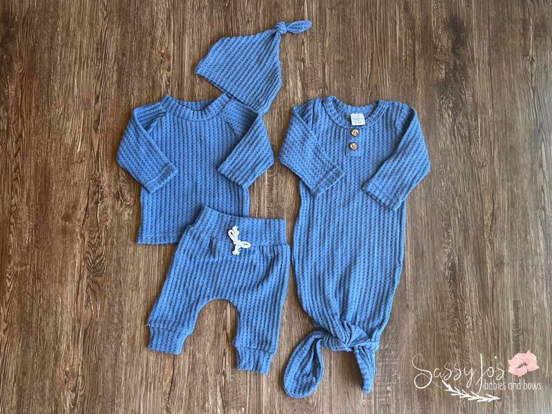 Newborn Baby boy knotted gown and coming home outfit set. Blue waffle knit baby girl outfit with long sleeve shirt, pants, tie hat, and knotted baby gown with two wooden buttons.