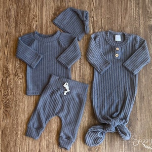 Newborn knotted baby gown bundle with 3 piece waffle knit outfit. Steel grey color. Bundle includes a very soft, brushed waffle knit long sleeve top, pants, tie hat and knotted baby gown with buttons.