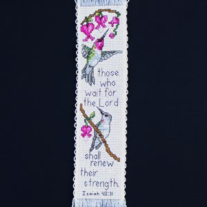 May include: A handmade cross-stitch bookmark featuring two hummingbirds and pink flowers on a white background. The text reads "those who wait for the Lord shall renew their strength. Isaiah 40:31."