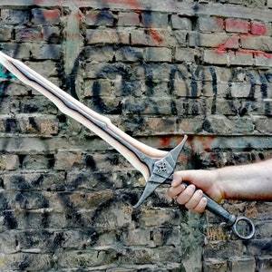 May include: A white and silver sword with a black handle and a ring on the end. The sword has a decorative design on the blade and a cross-shaped design on the pommel.