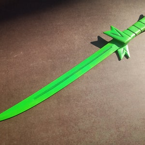 May include: A bright green sword with a decorative handle. The sword is made of wood and has a sharp point.