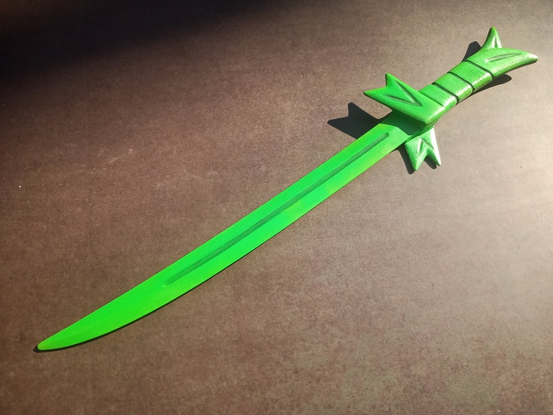 May include: A bright green sword with a decorative handle. The sword is made of wood and has a sharp point.