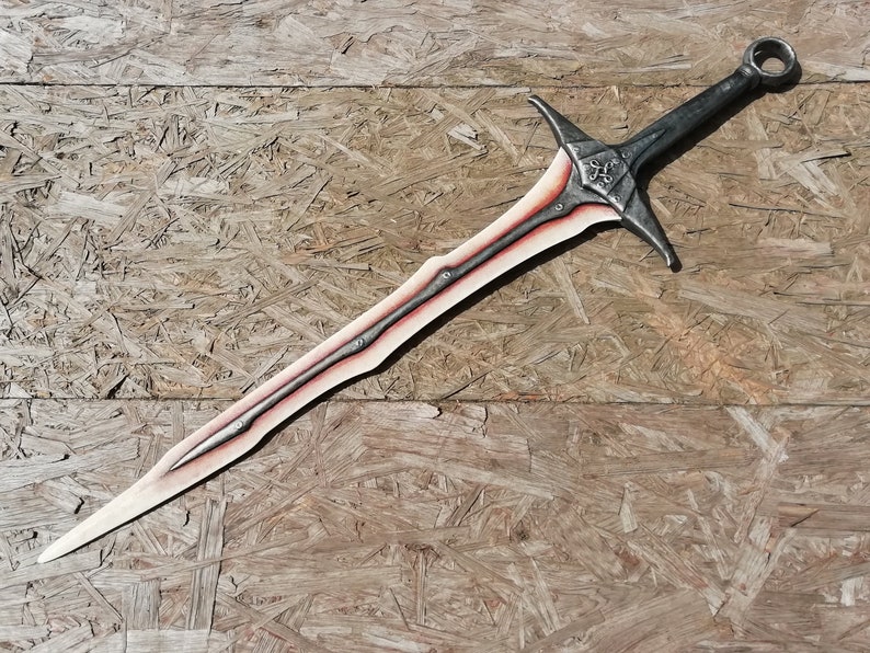 May include: A silver sword with a red stripe down the center of the blade. The sword has a decorative handle with a ring at the top.
