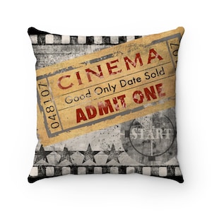 May include: A decorative throw pillow with a vintage movie ticket design. The ticket reads "Cinema" and "Good Only Date Sold Admit One". The background features a film strip and stars.