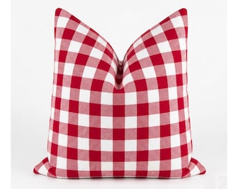 May include: A square throw pillow featuring a classic red and white gingham check pattern. The fabric displays a consistent grid of alternating red and white squares across the entire surface, creating a balanced and uniform textile design.