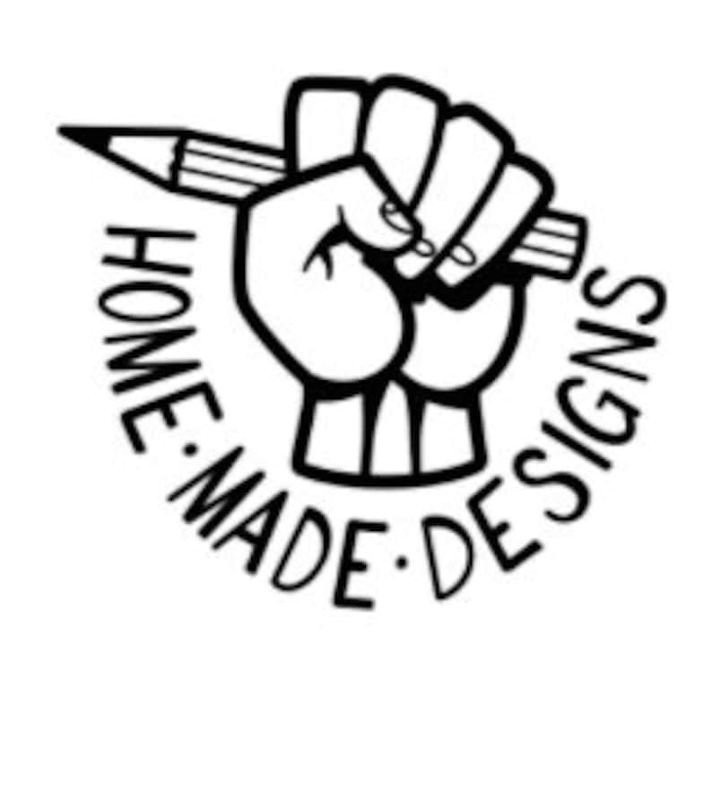 May include: Black and white illustration of a hand holding a pencil, with the words "HOME MADE DESIGNS" circling the hand.