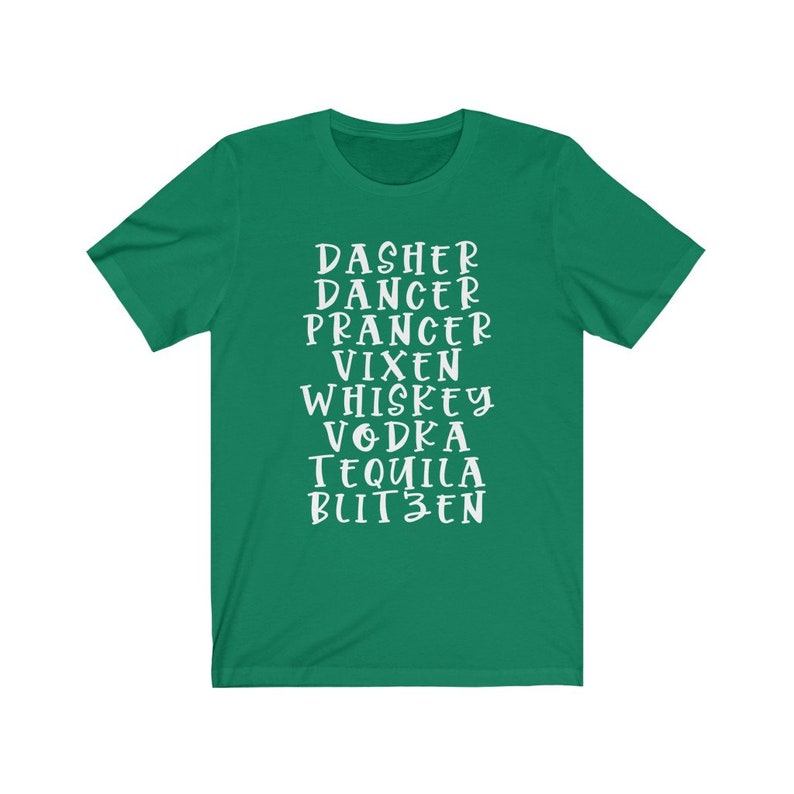 May include: A green t-shirt with white text listing holiday-themed words: Dasher, Dancer, Prancer, Vixen, Whiskey, Vodka, Tequila, and Blitzen. The shirt has short sleeves and a crew neck.
