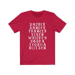 May include: A red t-shirt with white text. The text includes the names of Santa's reindeer, followed by the names of alcoholic beverages. The shirt is a crew neck and has short sleeves.