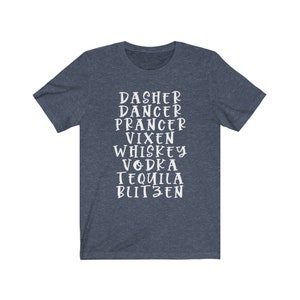 May include: A navy blue t-shirt with white text listing holiday-themed words: Dasher, Dancer, Prancer, Vixen, Whiskey, Vodka, Tequila, and Blitzen. The shirt is made of a soft material.