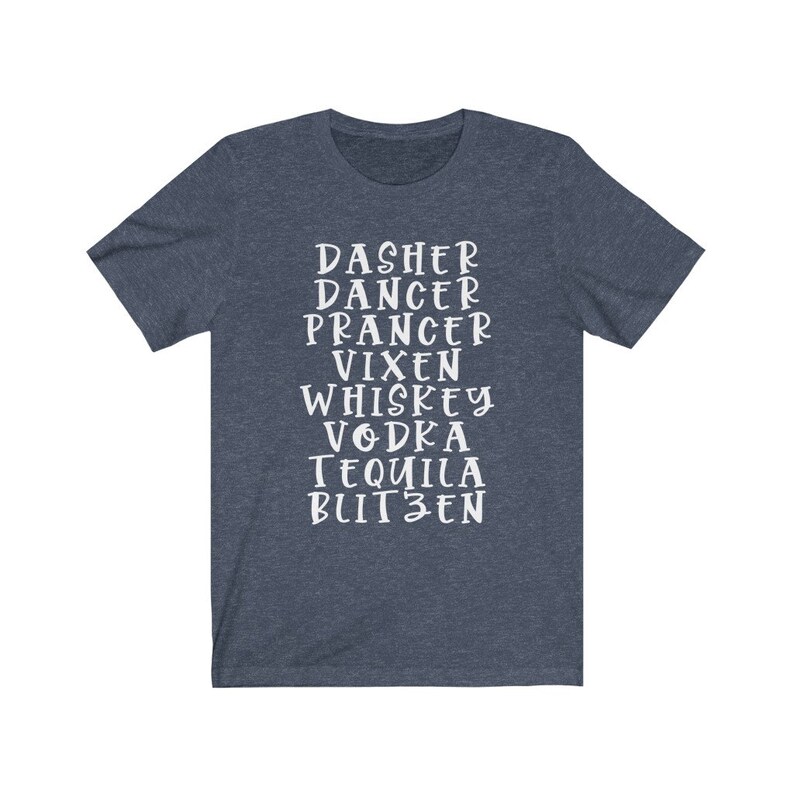 May include: A navy blue t-shirt with white text listing holiday-themed words: Dasher, Dancer, Prancer, Vixen, Whiskey, Vodka, Tequila, and Blitzen. The shirt is made of a soft material.